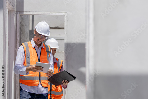 A portrait of an industrial man and woman asia engineer with tablet in a site home, working.