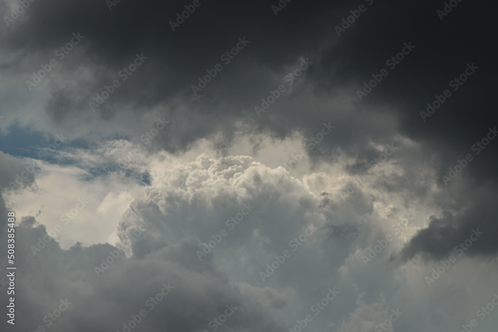 The sun shines through the clouds in the evening sky with dramatic light. The shape of the clouds evokes imagination and creativity, They can be used as wallpaper. No focus, specifically.