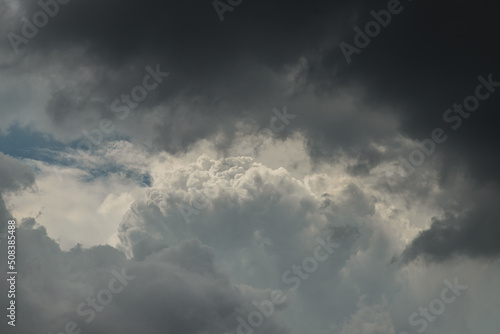 The sun shines through the clouds in the evening sky with dramatic light. The shape of the clouds evokes imagination and creativity, They can be used as wallpaper. No focus, specifically.