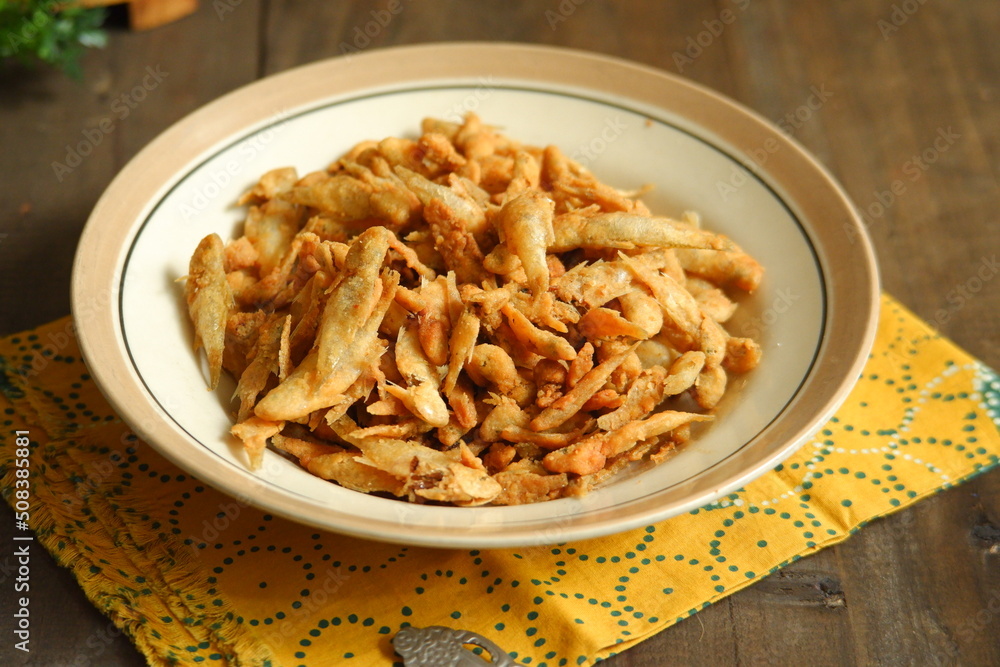 a plate of fried crispy fish on the table a plate of fried crispy fish on the table