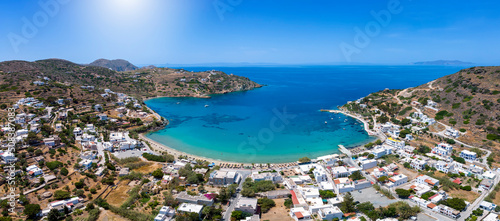 Panoramic aerial view of the bay and beach at Kini, Siros island, Cyclades, Greece, with turquoise sea and blue sky photo