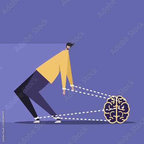 Conceptual illustration of imaginary strings of brain pulling back a man from moving ahead photo