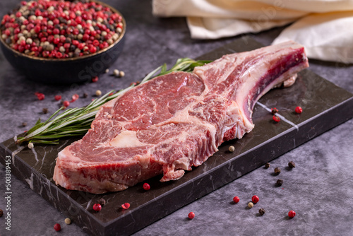 Veal chops on dark background. Fresh raw veal chops with spices. close up