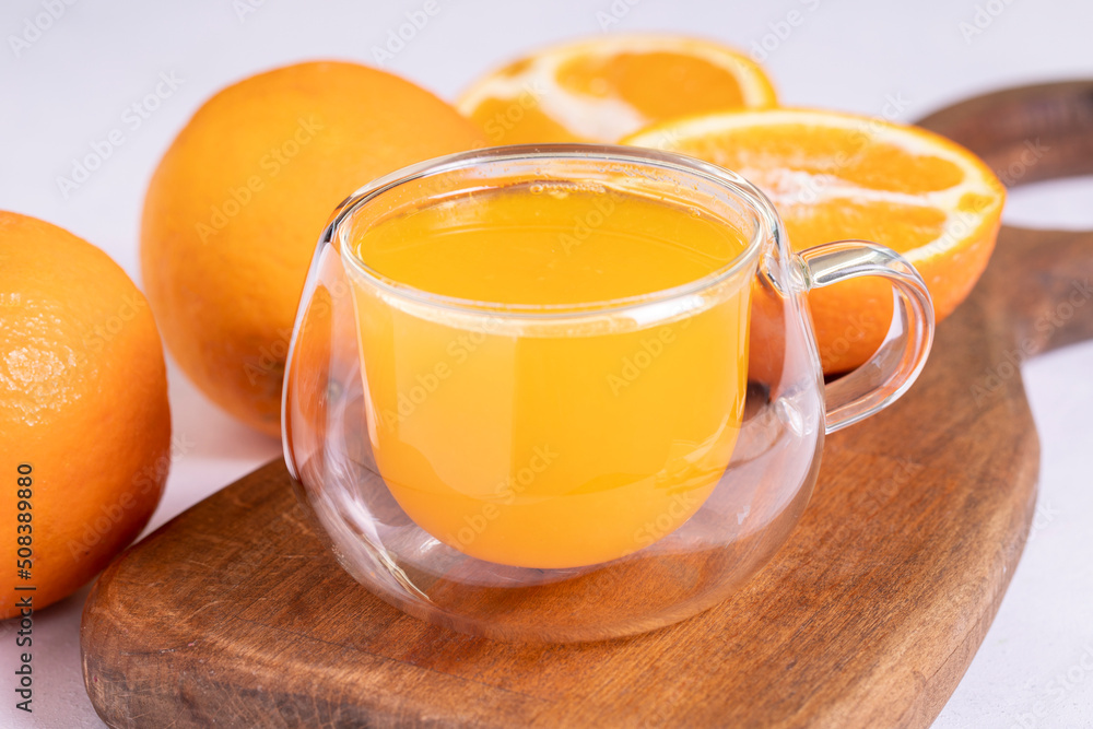 Freshly squeezed orange juice on a white background. Fresh orange juice. close up Freshly squeezed orange juice on a white background. Fresh orange juice. close up