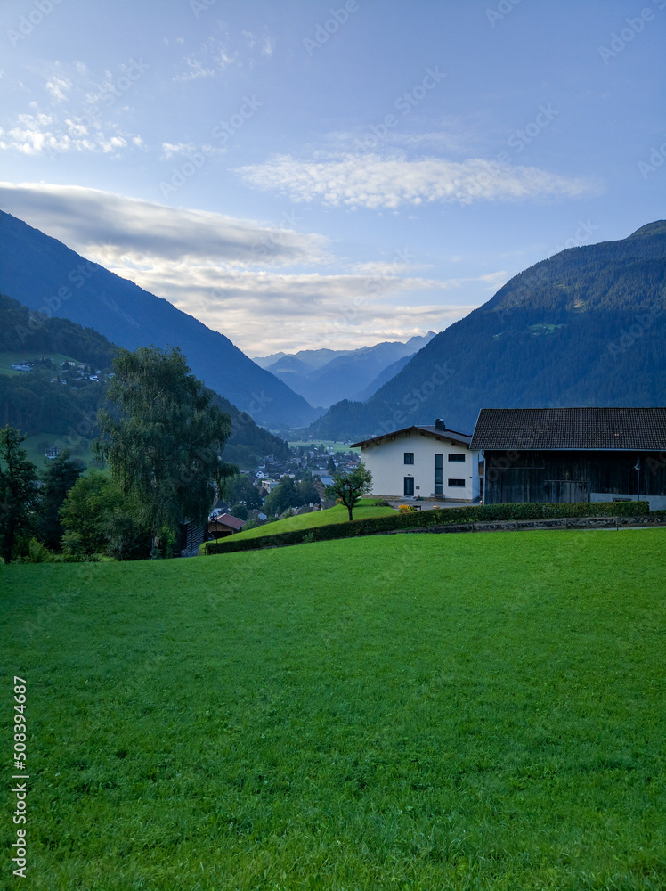 Scenic view of the Austrian village of Wolfurt against the backdrop of the Alps and green meadows. Vertical. Wolfurt, Austria Scenic view of the Austrian village of Wolfurt against the backdrop of the Alps and green meadows. Vertical. Wolfurt, Austria