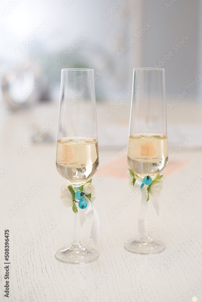 wedding glasses with champagne wine on the table decorated with flowers wedding glasses with champagne wine on the table decorated with flowers