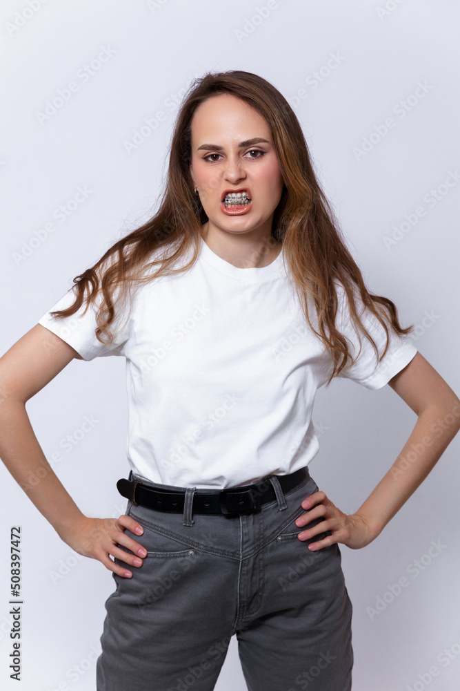 girl with brown hair in a white T-shirt and gray jeans girl with brown hair in a white T-shirt and gray jeans