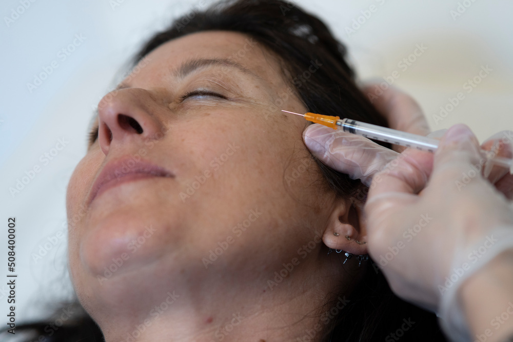 Middle age woman 40s getting lifting botox injection.Cosmetic procedures, Botox injections, hyaluronic acid.