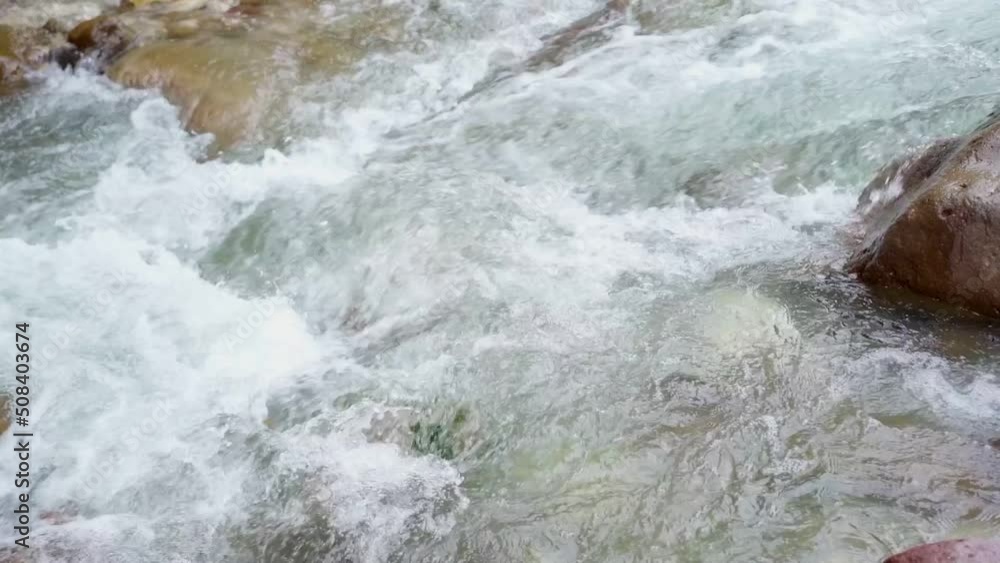 The flow of a stormy mountain river The flow of a stormy mountain river