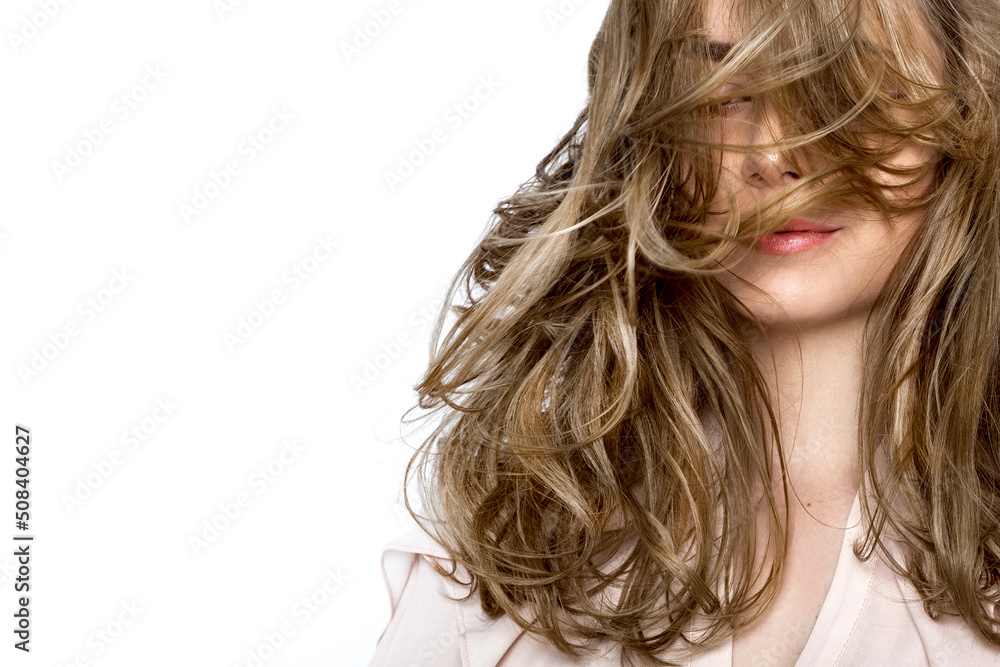 Portrait of a beautiful natural girl with beautiful healthy hair on a white background. A beautiful young girl with a perfect face and beautiful flowing hair. Beauty hair - concept. Portrait of a beautiful natural girl with beautiful healthy hair on a white background. A beautiful young girl with a perfect face and beautiful flowing hair. Beauty hair - concept.