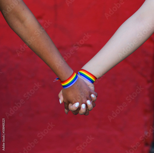HANDS OF GIRLS WHO LOVE EACH OTHER IN THE GAY PRIDE