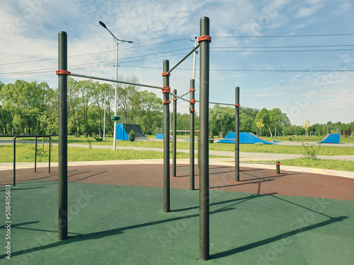 Sports field in a public park, horizontal bar and bars for outdoor gymnastics, sports activity for health