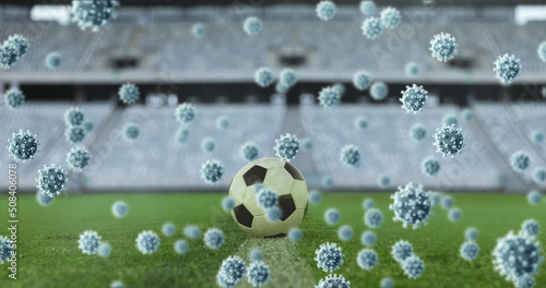 Covid-19 cells against soccer ball in sports stadium