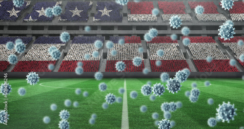Image of covid 19 cells over american flag in empty sports stadium