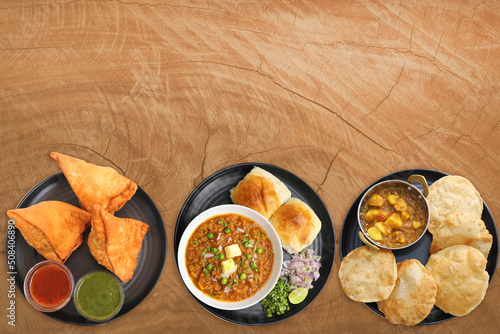 Assorted Indian snack dishes. Samosa, Pav Bhaji, Puri bhaji, Medu vada, Misal Pav, Pakode, Chakli, Sabudana vada, Alu vadi, Aloo tikki, Dahi Vada, Bhujiya. Vegetarian food banner. Copy Space Fast food photo