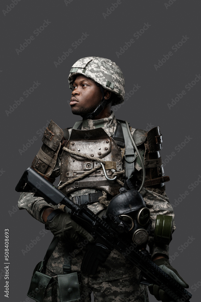 Portrait of african military man dressed in modern camouflage uniform holding rifle. Portrait of african military man dressed in modern camouflage uniform holding rifle.