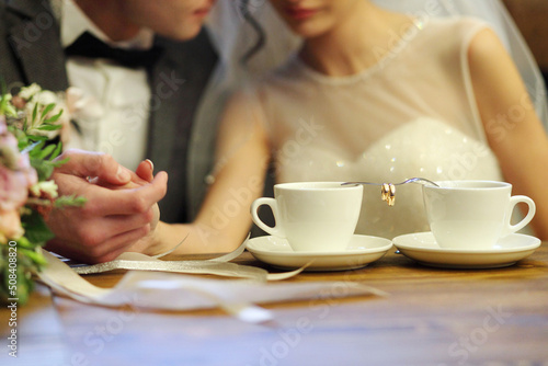 Bride and groom's Coffee time, coffee break.Hand in hand photo