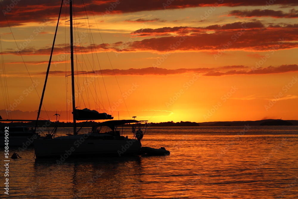 Sunset at the beach with sailing boats