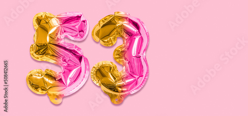 Rainbow foil balloon number, digit fifty three on a pink background. Birthday greeting card with inscription 53. Top view. Numerical digit. Celebration event, template. Banner
