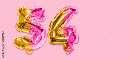 Rainbow foil balloon number, digit fifty four on a pink background. Birthday greeting card with inscription 54. Top view. Numerical digit. Celebration event, template. Banner photo