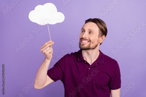 Photo of young cheerful man hold paper stick cloud plan rainy weather isolated over violet color background