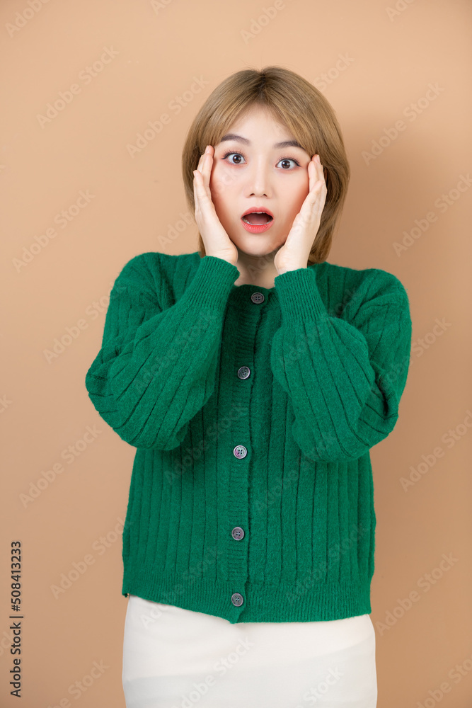 Surprised young asian lady raising hands and looking at copy space with excitement Surprised young asian lady raising hands and looking at copy space with excitement