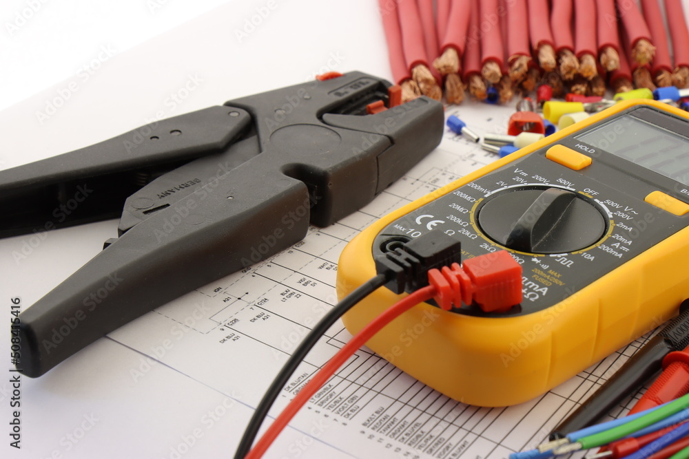 Multimeter and mounting tools in the electrical diagram close-up. Stock