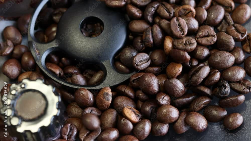 Close up shot of coffee beans falling into the grinder of a coffee maker. Close up shot of coffee beans falling into the grinder of a coffee maker.