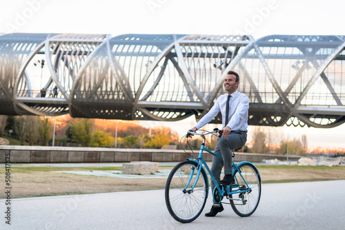 Business man riding a vintage bicycle in the city.