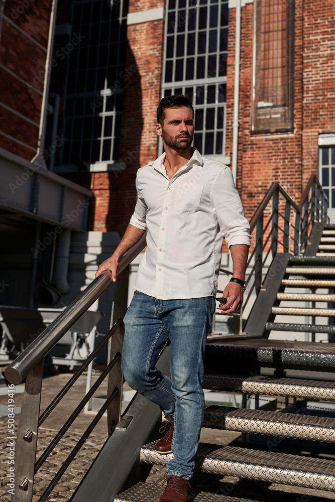 Bearded man walking on steps