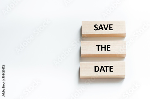 Save the Date word written on wood block. Save the Date text on table, concept