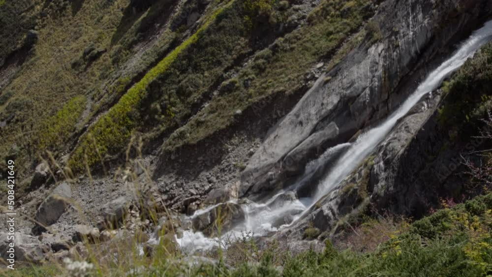 Natural Waterfall in the Himalayas, Garhwal Himalayan range, near Kedarnath Temple in Uttarakhand, India. Falling water hitting water surface, some huge rocks. Lush green leaf. Natural Waterfall in the Himalayas, Garhwal Himalayan range, near Kedarnath Temple in Uttarakhand, India. Falling water hitting water surface, some huge rocks. Lush green leaf.