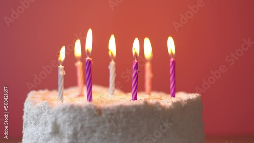 Burning candles are blown out on a cute girly birthday cake