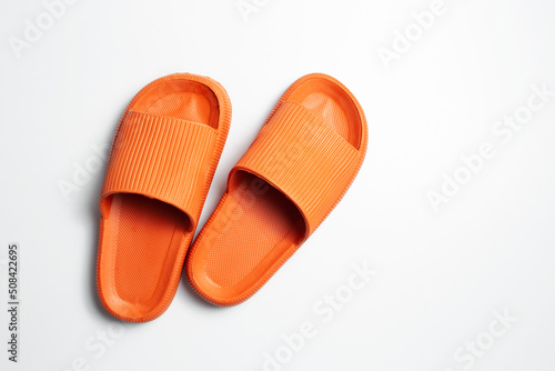 Top view of colourful slippers of orange color, isolated on white background. photo
