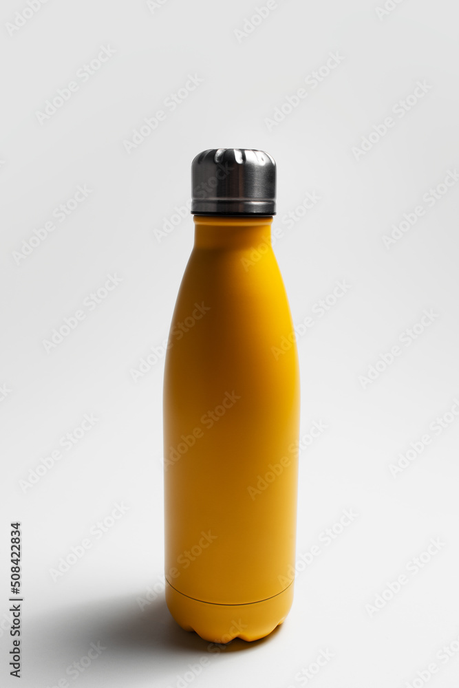 Close-up of reusable eco water bottle of yellow on white studio background. Close-up of reusable eco water bottle of yellow on white studio background.