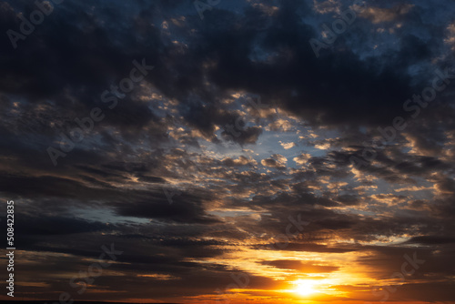 Colourful landscape of beautiful sunset with dark clouds.