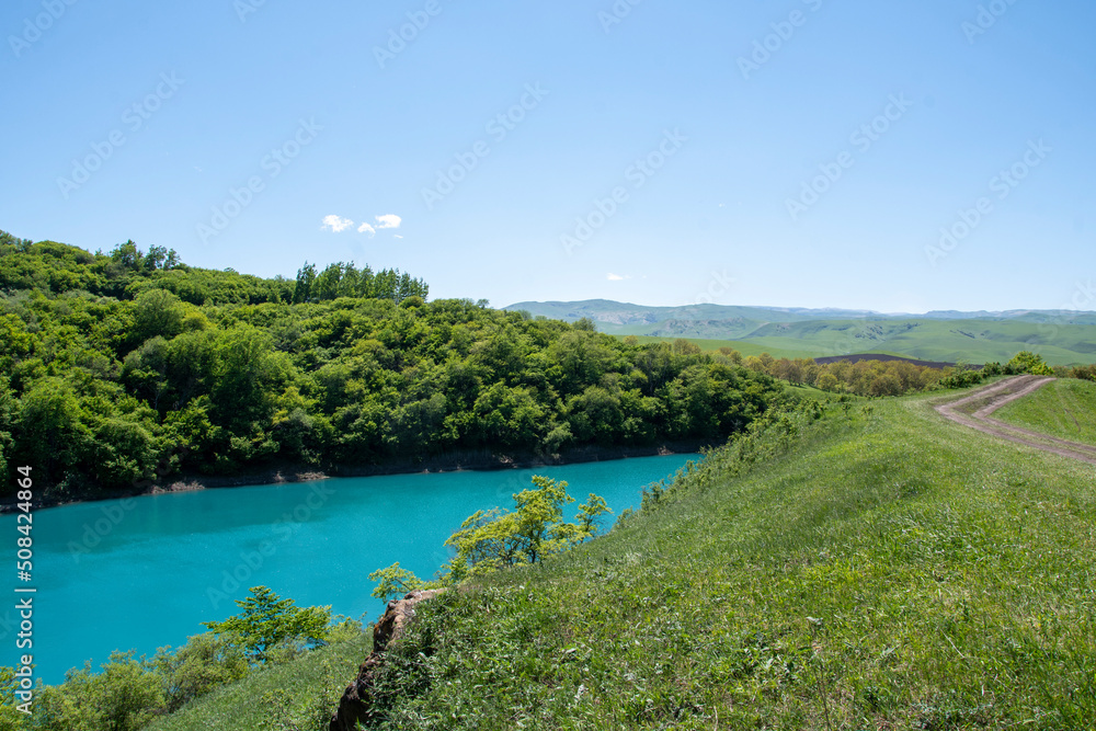 Blue karst lake in the mountains in summer