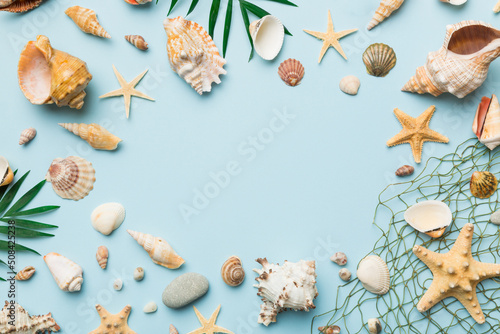 Summer time concept Flat lay composition with beautiful starfish and sea shells on colored table, top view with copy space for text