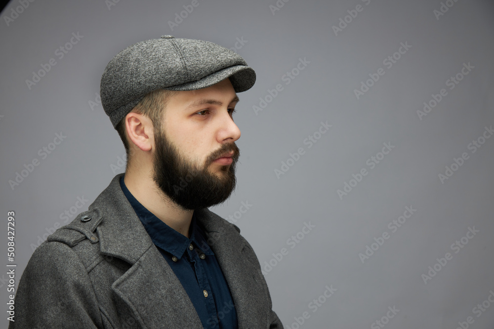 Man with a beard on a dark background, English classic clothes Man with a beard on a dark background, English classic clothes