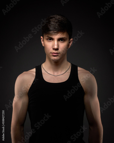 Teen athletic body on dark background