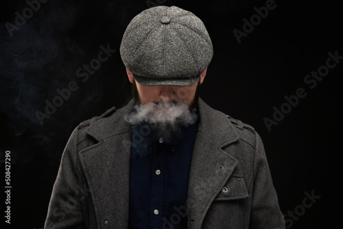 Man with a beard on a dark background, English classic clothes photo