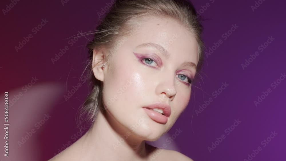 Camera zooming in on the face of a beautiful girl model with bright