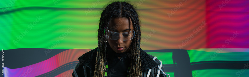 African american woman in smart glasses standing on colorful abstracted background, banner.