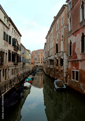Venice canal view. Colorful facades, boats, calm river water. Beautiful architecture of Italy. Most romantic travel destinations.  © Maya
