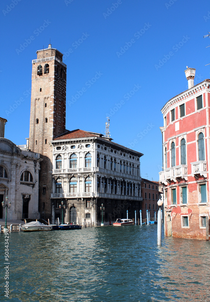 Beautiful city view of Venice Canals, Streets and Monuments. Colorful buildings near water. Sunny day in Italy. Tourist destinations concept. 