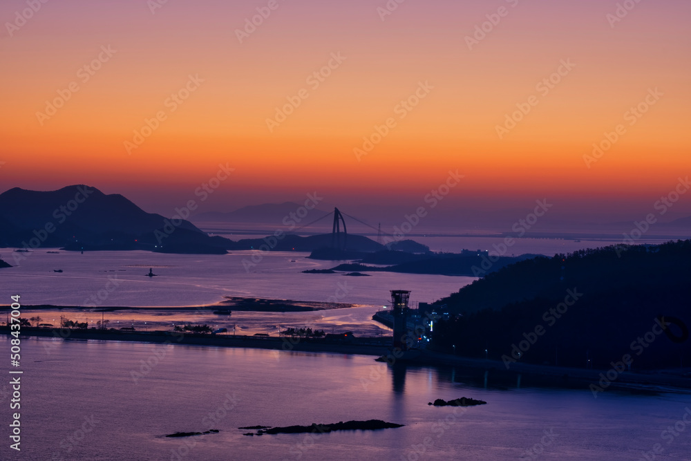 Scenic view of sea and islands during sunrise