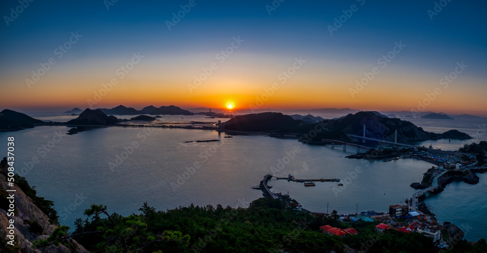 Scenic view of sea and islands during sunrise
