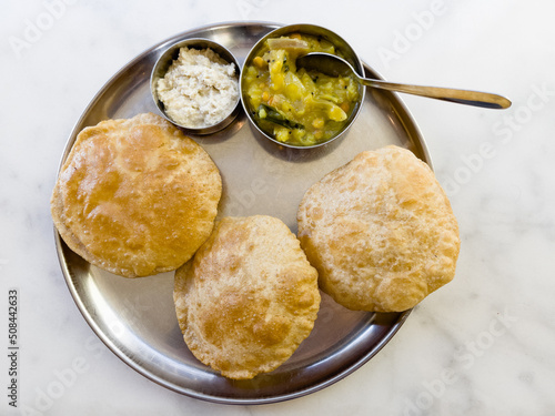 Puri served with bhaji and chutney photo