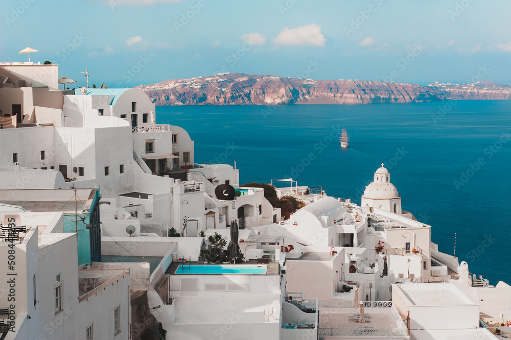 White architecture on Santorini island, Greece. Beautiful seascape at sunrise. Travel and summer vacations concept