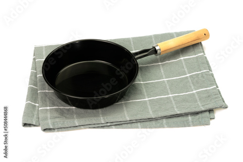 Empty fry pan with cloth isolated on white background. Mock up. Selective focus.